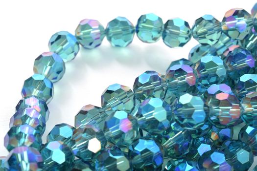 Beautiful Light Blue Glass Sparkle Crystal Isoalted Beads on white background. Use for diy beaded jewelry. Space for text