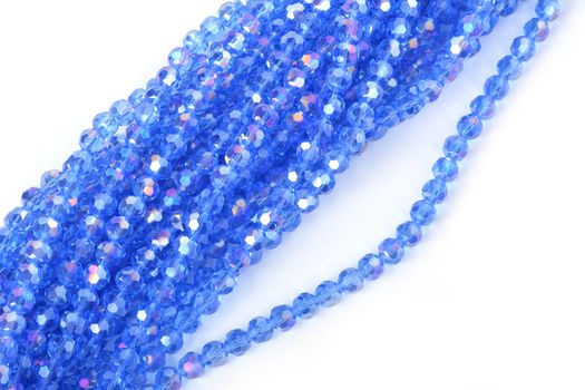 Beautiful Light Blue Glass Sparkle Crystal Isoalted Beads on white background. Use for diy beaded jewelry. Space for text