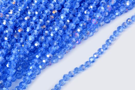 Beautiful Light Blue Glass Sparkle Crystal Isoalted Beads on white background. Use for diy beaded jewelry. Space for text
