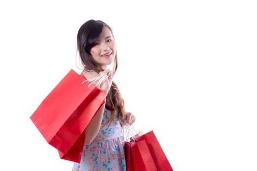 happy excited woman standing and holding colorful shopping bags isolated on a white background.