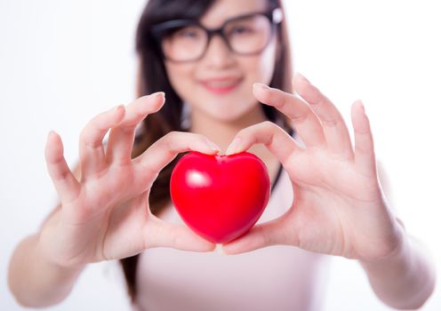 Young asian woman show heart hand sign on white background.