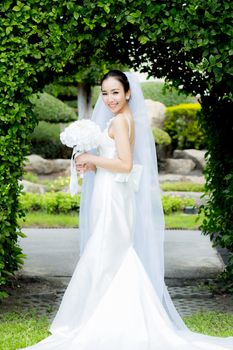 beautiful young woman on wedding day in white dress in the garden - Female portrait in the park - Selective focus.