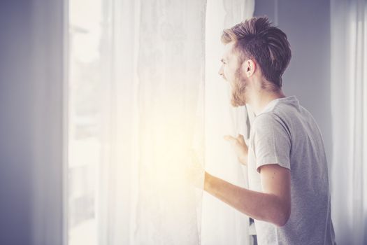 Screaming man with window in the bedroom.