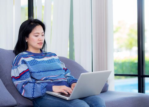 Closeup computer notebook on sofa with asian woman for work in lifestyle of woman concept