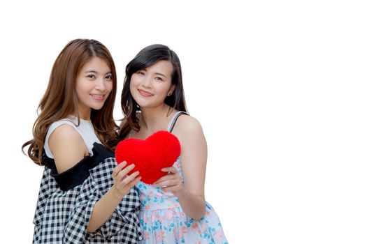 Young asian two women show hand holdding pillow heart shape  sign on white background.