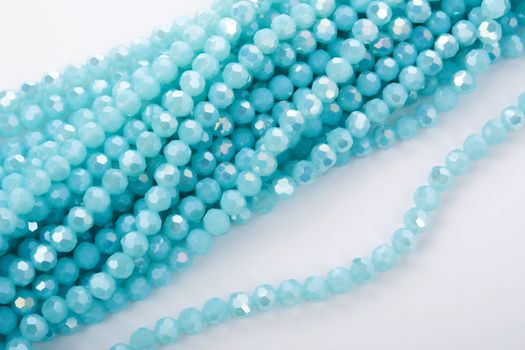 Beautiful Light Blue Glass Sparkle Crystal Isoalted Beads on white background. Use for diy beaded jewelry. Space for text