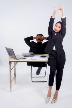 Confident businesswoman and businessman in office with stretch in office.