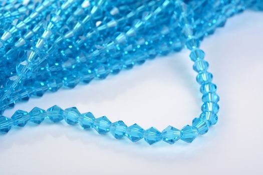 Beautiful Light Blue Glass Sparkle Crystal Isoalted Beads on white background. Use for diy beaded jewelry. Space for text