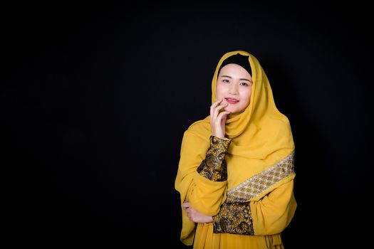 Portrait of beautiful muslim asian woman over black background with happy muslim woman, Age 20-30 years.