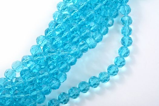 Beautiful Light Blue Glass Sparkle Crystal Isoalted Beads on white background. Use for diy beaded jewelry. Space for text