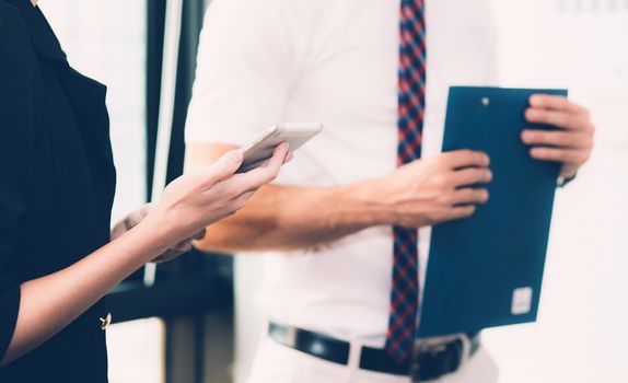 Business people meeting closeup of woman hand holdding smartphone with other businessman.