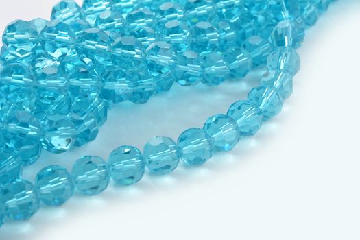 Beautiful Light Blue Glass Sparkle Crystal Isoalted Beads on white background. Use for diy beaded jewelry. Space for text