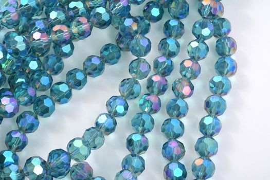 Beautiful Light Blue Glass Sparkle Crystal Isoalted Beads on white background. Use for diy beaded jewelry. Space for text