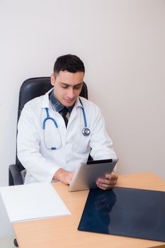 doctor working with using tablet computer in his office.