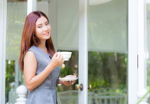 Beautiful businesswoman have enjoyed in the garden with coffee.