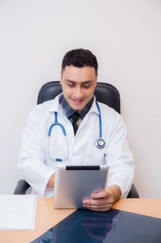 doctor working with using tablet computer in his office.