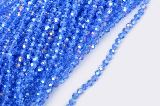 Beautiful Light Blue Glass Sparkle Crystal Isoalted Beads on white background. Use for diy beaded jewelry. Space for text