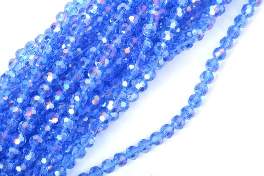 Beautiful Light Blue Glass Sparkle Crystal Isoalted Beads on white background. Use for diy beaded jewelry. Space for text