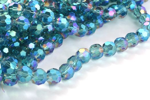 Beautiful Light Blue Glass Sparkle Crystal Isoalted Beads on white background. Use for diy beaded jewelry. Space for text