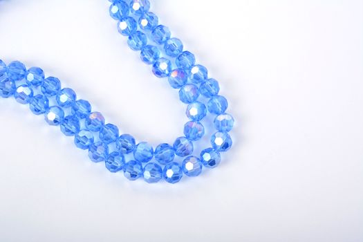Beautiful Light Blue Glass Sparkle Crystal Isoalted Beads on white background. Use for diy beaded jewelry. Space for text