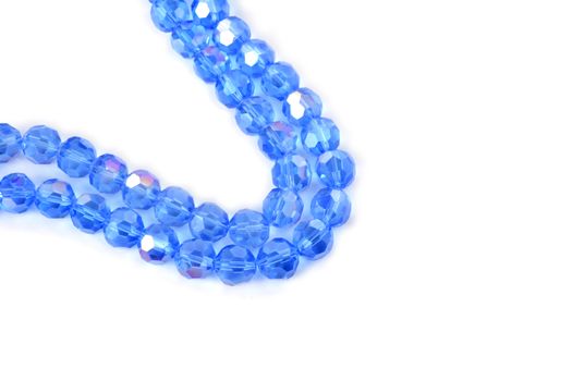 Beautiful Light Blue Glass Sparkle Crystal Isoalted Beads on white background. Use for diy beaded jewelry. Space for text