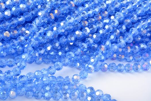 Beautiful Light Blue Glass Sparkle Crystal Isoalted Beads on white background. Use for diy beaded jewelry. Space for text