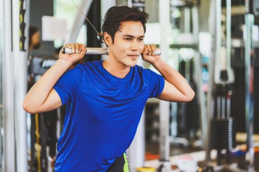 Young Asian man wearing sportswear doing excecise with the bar in gym fitness sport complex, posture position, sport club community, sports and healthcare concept,
