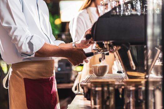 Asian Barista preparing cup of coffee, espresso with latte or cappuccino for customer order in coffee shop,making espresso, Small business owner and startup in coffee shop and restaurant concept