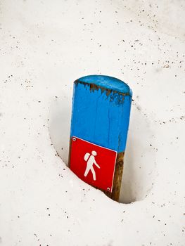 Sign for a hiking trail in the snowy landscape of Norway.