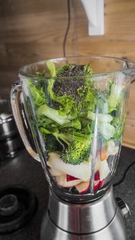 Blender with healthy ingredients for a delicious green smoothie.