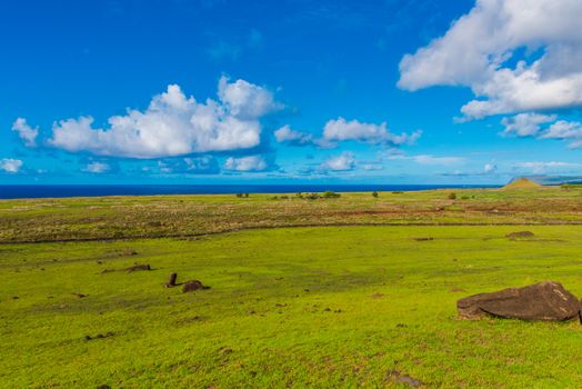 A sweeping view of the Easter Island  landscape leading to the Pacific Ocean.