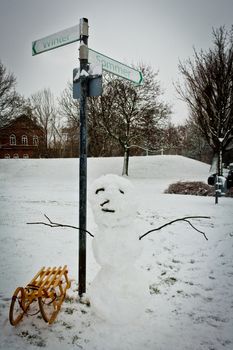 Sign in winter. Snowman with sledge and signage "Winter or Summer"