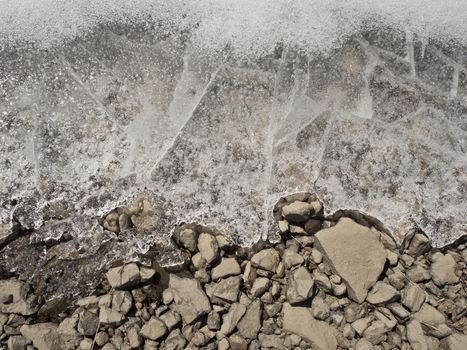 Ground texture. Ice layer over stones.