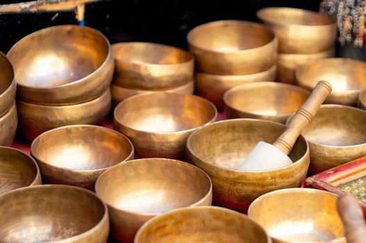 Brass singing musical bowls placed in a shop in mcleodganj himachal pradesh. Tibetan singing bowls are a popular souvenir helps in relaxation and fun