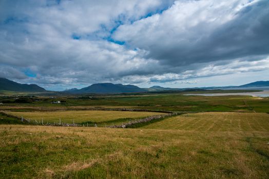 A patchwork of green and brown in the hills and valleys of County Mayo farmland on the Irsich coast.