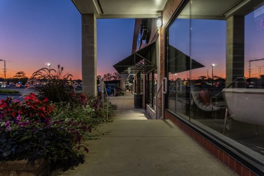 Vacant modern store building exterior at sunset with no people.