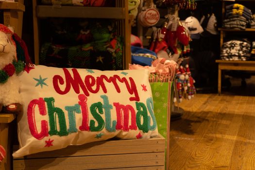 Merry Christmas pillow closeup on a blurred market background