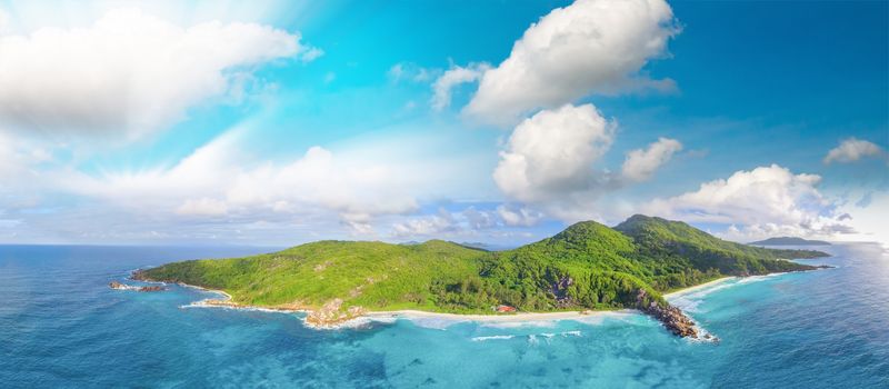 Amazing aerial view of Grand Anse in La Digue Island, Seychelles. Ocean and forest.