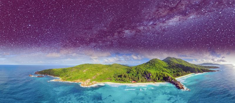 Aerial panoramic view of Tropical Island at night with stars and milky way.