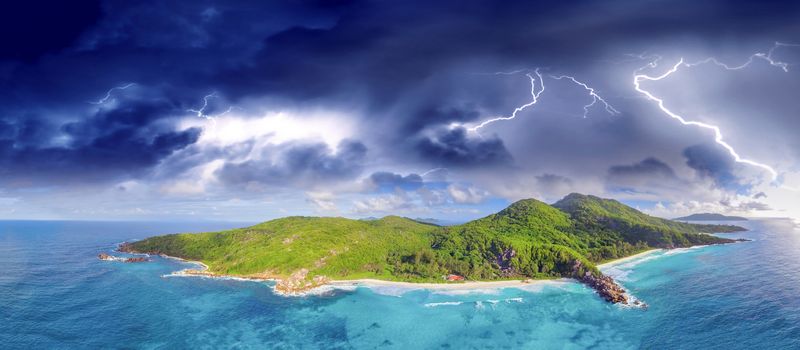 Aerial panoramic view of Tropical Island with storm approaching. Climate change concept.