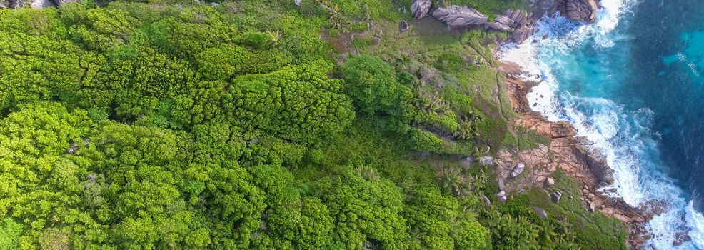 Amazing aerial view of Grand Anse in La Digue Island, Seychelles. Ocean and forest.
