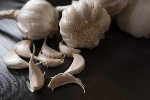 a shot of garlic's & cloves on wooden background