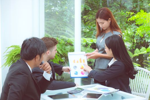 young business people making meeting and talking for analyzing marketing with graph working at office on desk.