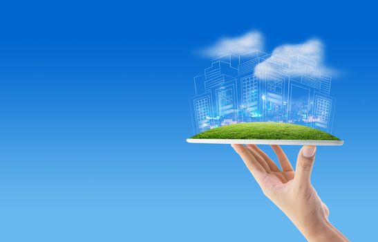hand holding tablet of businessman with drawing sketches of construction project on nature background.