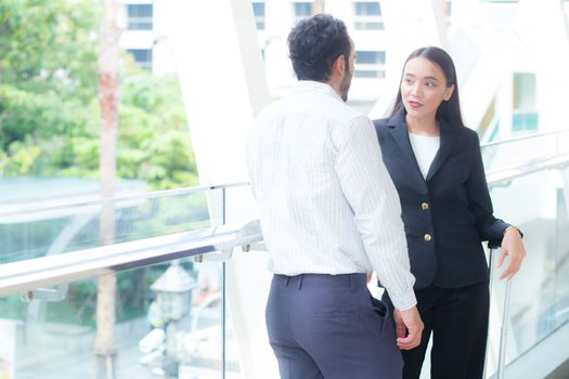 Businesswoman talking business partner standing conversation about the work, boss discussing with employee.