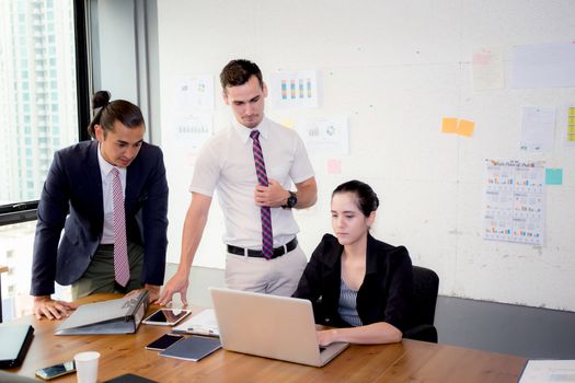 Business team having using laptop during a meeting and presents.