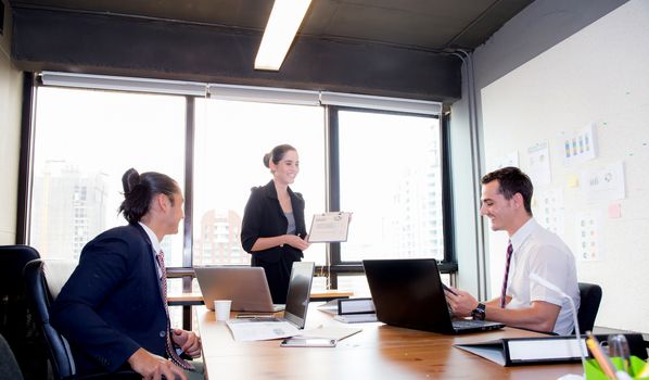 businesswoman presentation to a group in meeting.