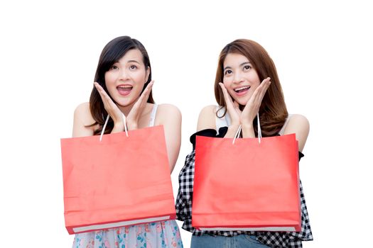 Two beautiful smiling asian young women with shopping sale bags isolated on white background.