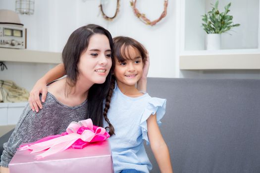 happy of mother and daughter asian with gift with pink ribbon and daughter kissing mother, Happy family concept. Happy mother's day.