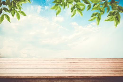 Table top, desk of empty space blue sky with leaves on top, can be used for display your products.